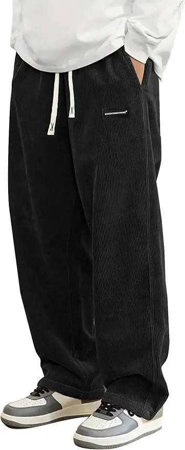 A pair of Hidkat corduroy wide leg sweatpants in black, shown to display the loose fit and the elastic drawstring waistband